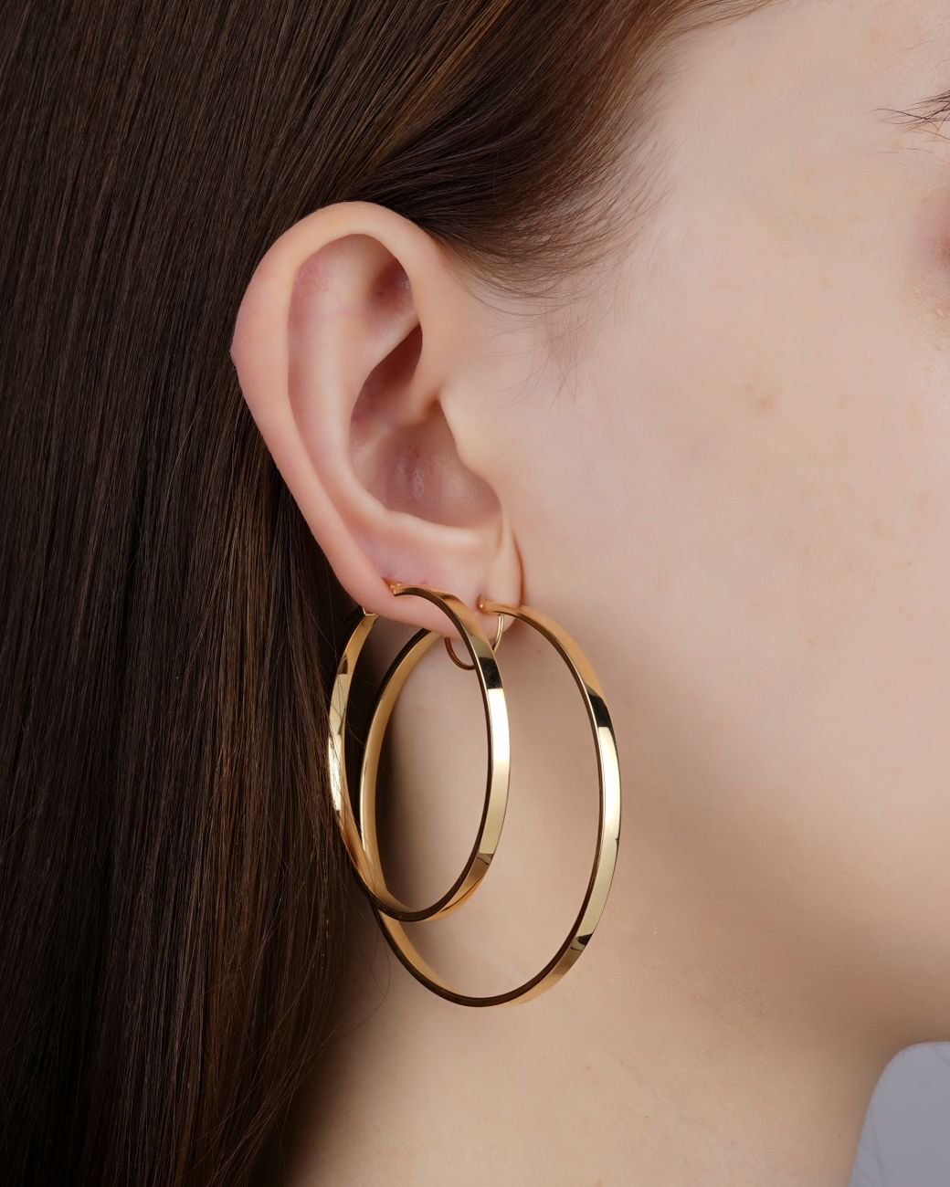 golden hoops in ear